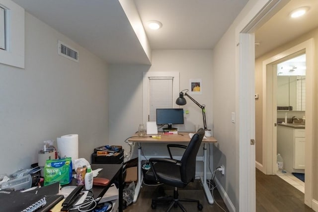 office featuring dark wood-type flooring and a sink