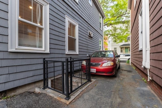 view of property exterior with a gate and fence