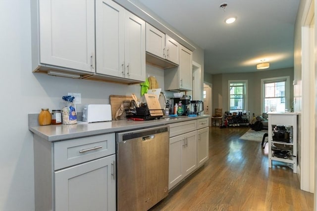 kitchen featuring stainless steel dishwasher, wood finished floors, light countertops, and recessed lighting