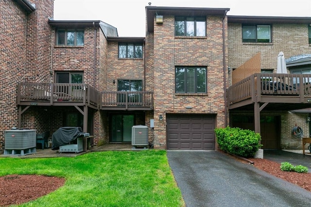 33 Cobblestone Ln Unit 33, Worcester, MA 01606 - view of building exterior with central air condition unit, an attached garage, and driveway