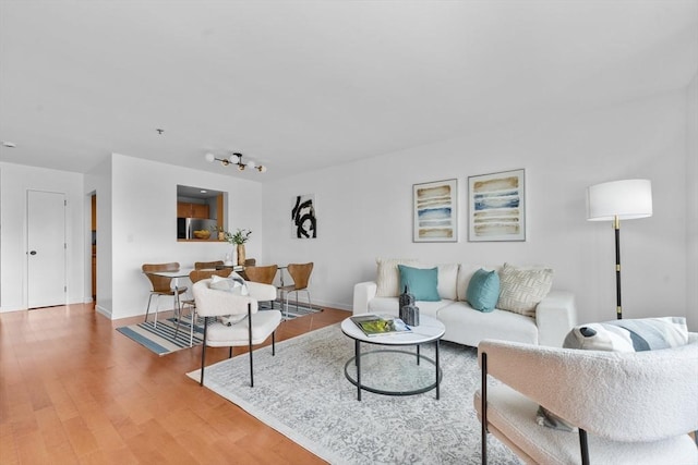 living room with light wood finished floors and baseboards