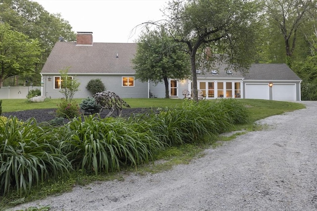 697 Rte 197, Woodstock, CT 06281 - view of front facade featuring a chimney, a garage, and gravel driveway