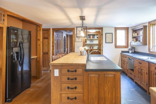 697 Rte 197, Woodstock, CT 06281 - kitchen featuring black refrigerator with ice dispenser, dishwasher, open shelves, a kitchen island with sink, and brown cabinetry