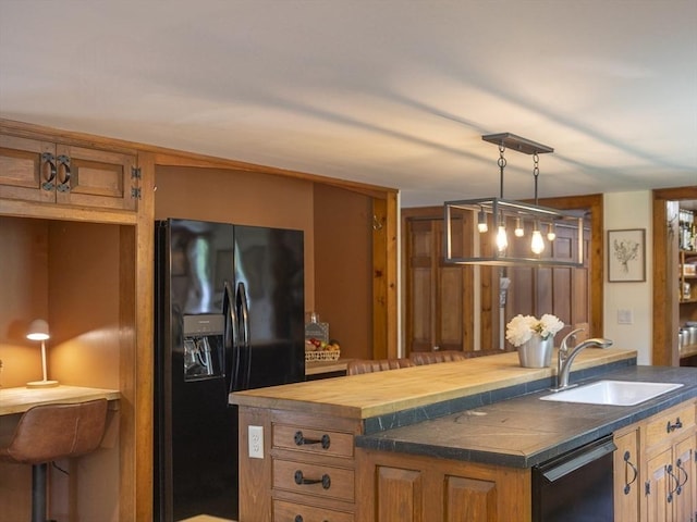 697 Rte 197, Woodstock, CT 06281 - kitchen with black appliances, a center island with sink, brown cabinets, decorative light fixtures, and butcher block countertops
