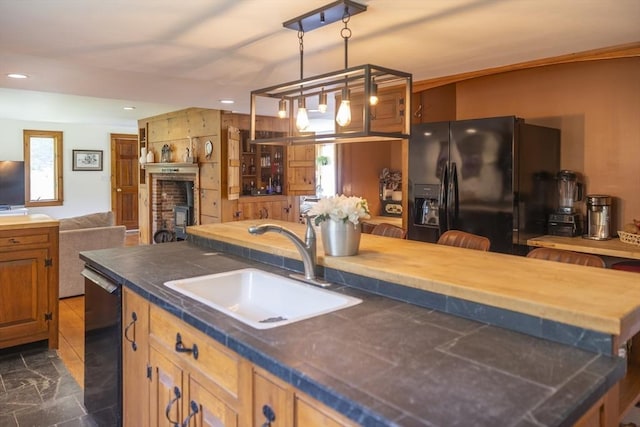 697 Rte 197, Woodstock, CT 06281 - kitchen featuring black fridge with ice dispenser, dishwasher, a fireplace, open floor plan, and hanging light fixtures