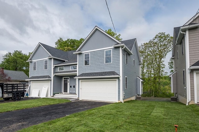59A Mount Ave, Worcester, MA 01606 - traditional home with driveway, a front yard, an attached garage, a shingled roof, and cooling unit