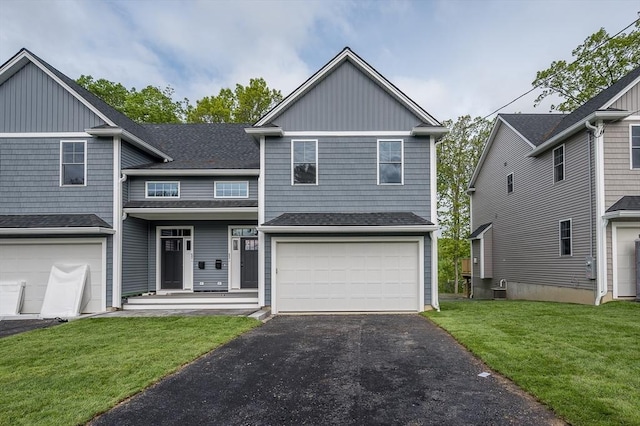 59A Mount Ave, Worcester, MA 01606 - view of front of property with a front lawn, asphalt driveway, an attached garage, and board and batten siding