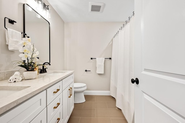 59A Mount Ave, Worcester, MA 01606 - full bathroom with double vanity, toilet, baseboards, and tile patterned flooring