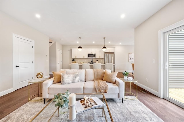 59A Mount Ave, Worcester, MA 01606 - living room featuring light wood-style flooring, baseboards, recessed lighting, and plenty of natural light