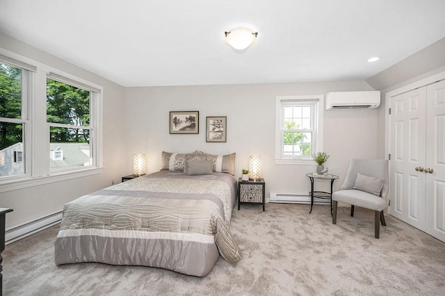 15 Eustis Ave, Wakefield, MA 01880 - carpeted bedroom with a baseboard heating unit, a wall mounted air conditioner, baseboard heating, and a closet