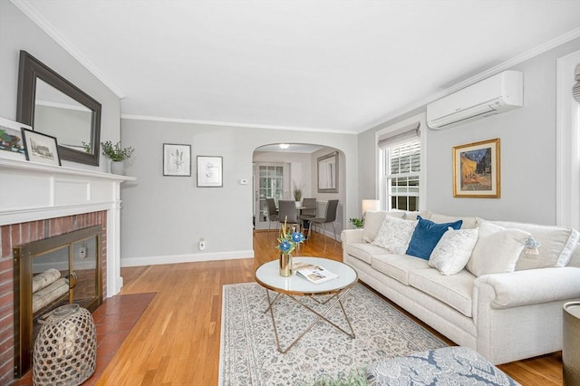 15 Eustis Ave, Wakefield, MA 01880 - living room featuring a wall mounted air conditioner, arched walkways, wood finished floors, crown molding, and a fireplace