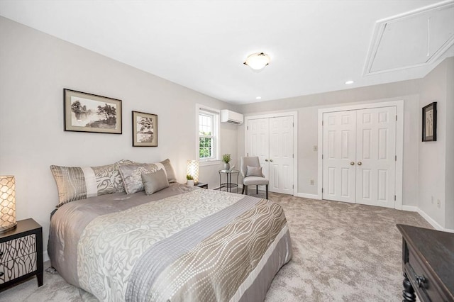 15 Eustis Ave, Wakefield, MA 01880 - bedroom with a wall unit AC, two closets, attic access, baseboards, and recessed lighting