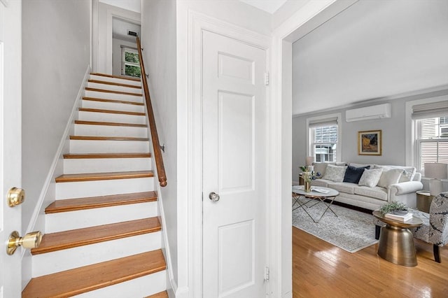 15 Eustis Ave, Wakefield, MA 01880 - staircase with a wall mounted AC and wood finished floors