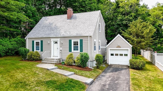 15 Eustis Ave, Wakefield, MA 01880 - cape cod house featuring a chimney, an outbuilding, a detached garage, driveway, and roof with shingles