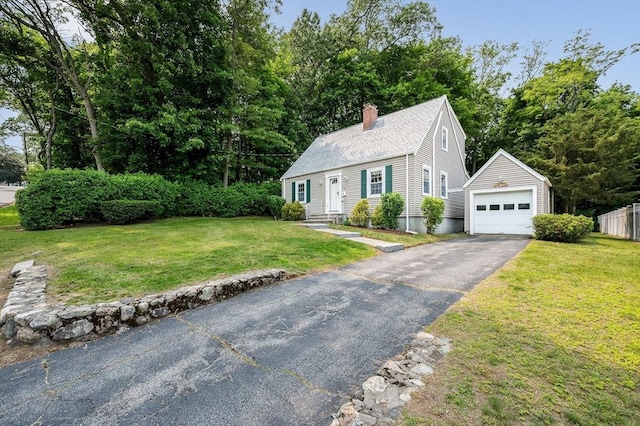 15 Eustis Ave, Wakefield, MA 01880 - cape cod house with an outbuilding, driveway, a chimney, a detached garage, and a front yard
