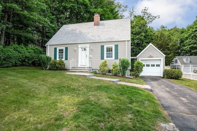 15 Eustis Ave, Wakefield, MA 01880 - cape cod house with an outbuilding, a chimney, asphalt driveway, a detached garage, and roof with shingles