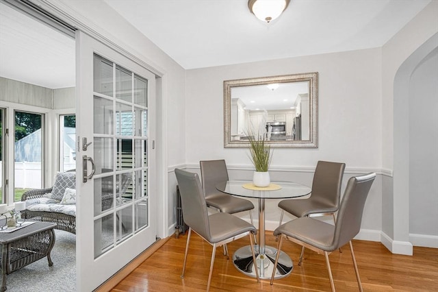 15 Eustis Ave, Wakefield, MA 01880 - dining area with wood finished floors, arched walkways, and baseboards