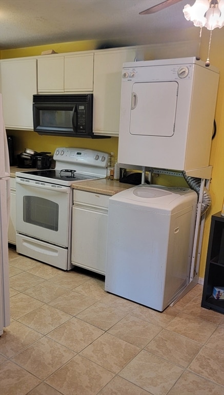 kitchen with stacked washer / dryer, white appliances, ceiling fan, and white cabinets