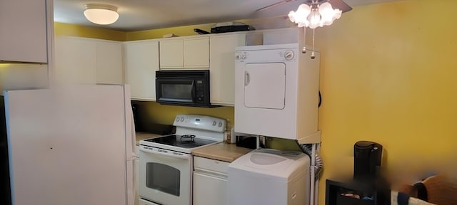 kitchen with stacked washer / dryer, white appliances, ceiling fan, and white cabinets