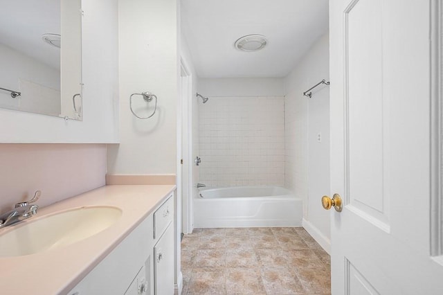 bathroom with tiled shower / bath combo, vanity, and tile patterned floors