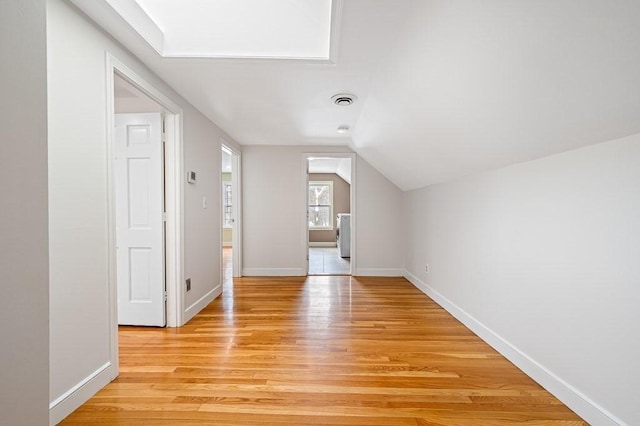 bonus room featuring lofted ceiling and light hardwood / wood-style flooring