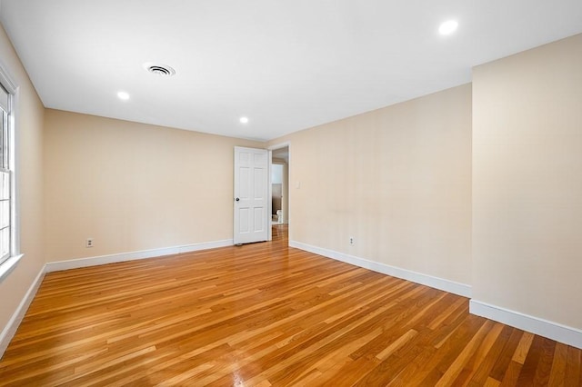 spare room featuring light hardwood / wood-style floors