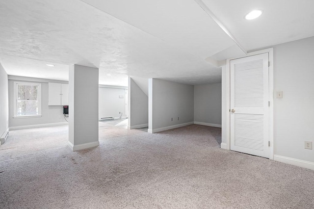 basement featuring light colored carpet