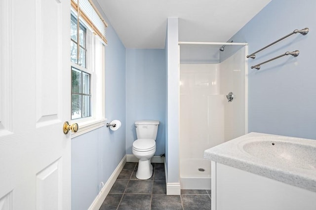 bathroom with tile patterned flooring, toilet, vanity, and walk in shower