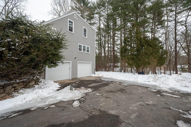 snow covered property featuring a garage