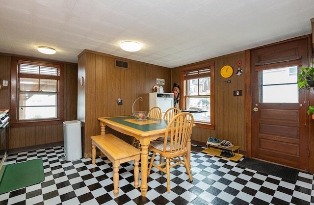 30 Everett St, Woburn, MA 01801 - dining area featuring tile patterned floors and wood walls