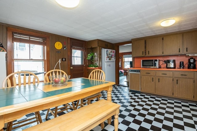 30 Everett St, Woburn, MA 01801 - dining space featuring tile patterned floors, plenty of natural light, and wooden walls