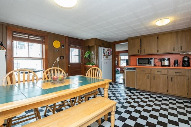 30 Everett St, Woburn, MA 01801 - dining space with tile patterned floors, plenty of natural light, and wooden walls