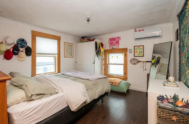 30 Everett St, Woburn, MA 01801 - bedroom with a wall mounted air conditioner, dark wood-style floors, and baseboards