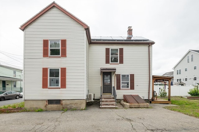 30 Everett St, Woburn, MA 01801 - view of front of house with roof mounted solar panels, a chimney, and entry steps