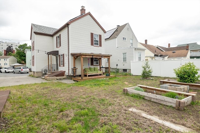 30 Everett St, Woburn, MA 01801 - back of property featuring a garden, a chimney, and a deck