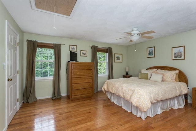 29 Benjamin Landing Ln Unit 29, Franklin, MA 02038 - bedroom featuring attic access, wood finished floors, baseboards, and a ceiling fan