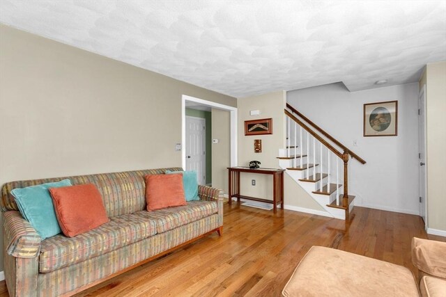 29 Benjamin Landing Ln Unit 29, Franklin, MA 02038 - living room with wood finished floors, stairs, and baseboards