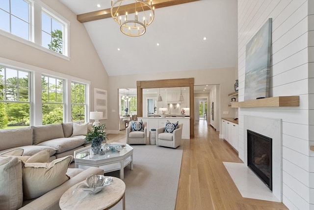 1 Beech Tree Ln, Lexington, MA 02421 - living area with high vaulted ceiling, plenty of natural light, a chandelier, light wood finished floors, and a premium fireplace