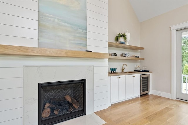 1 Beech Tree Ln, Lexington, MA 02421 - detailed view of wine cooler, wet bar, wood finished floors, a high end fireplace, and baseboards