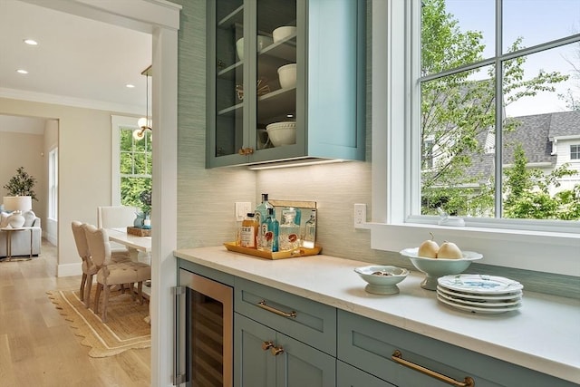 1 Beech Tree Ln, Lexington, MA 02421 - indoor dry bar with beverage cooler, backsplash, healthy amount of natural light, light wood-type flooring, and ornamental molding