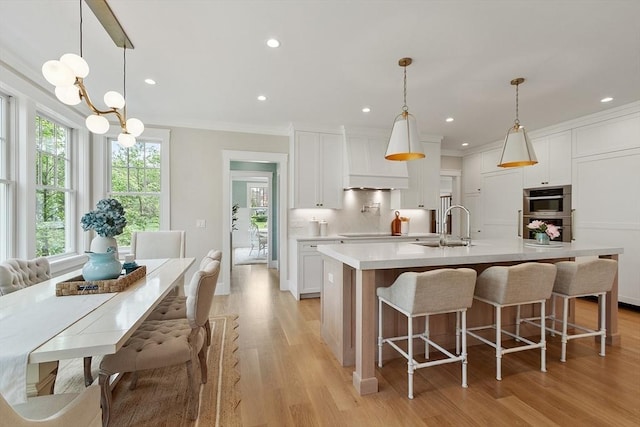 1 Beech Tree Ln, Lexington, MA 02421 - kitchen featuring stainless steel double oven, a sink, light countertops, white cabinetry, and crown molding