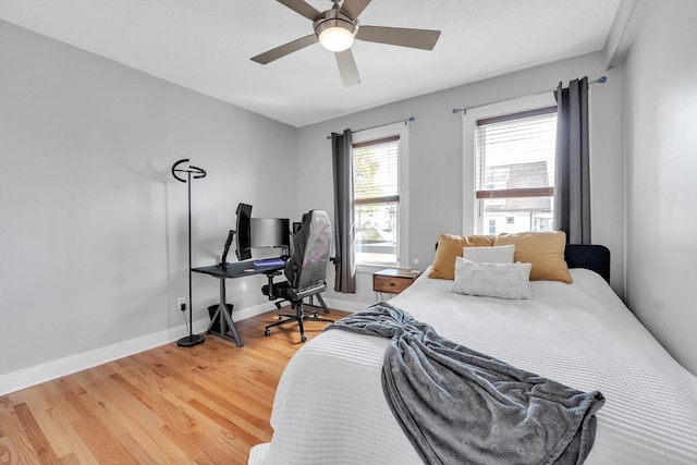 bedroom featuring baseboards, ceiling fan, and light wood-type flooring