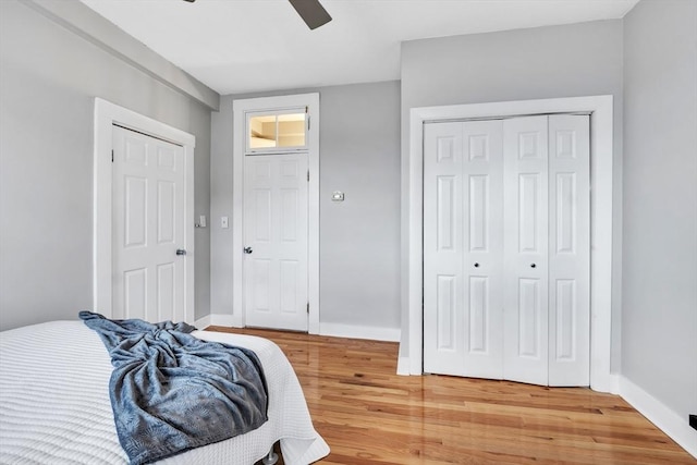 bedroom featuring baseboards, ceiling fan, and light wood finished floors