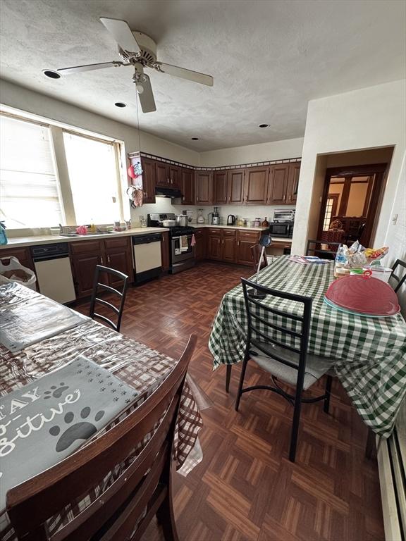 dining room with a textured ceiling and ceiling fan