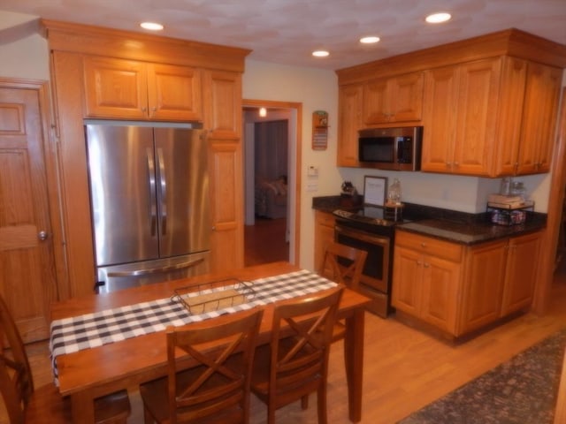 kitchen featuring light wood-type flooring, stainless steel appliances, and recessed lighting