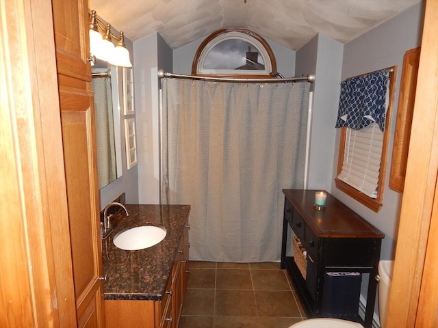 bathroom featuring tile patterned flooring, curtained shower, toilet, and vanity