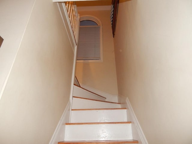 stairway featuring baseboards