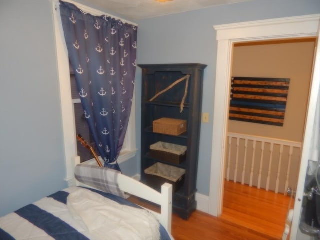 bedroom with wood finished floors