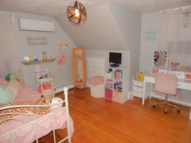 bedroom featuring a baseboard radiator, lofted ceiling, an AC wall unit, and wood finished floors