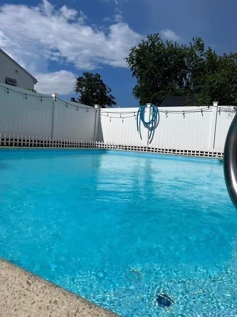 view of pool featuring fence